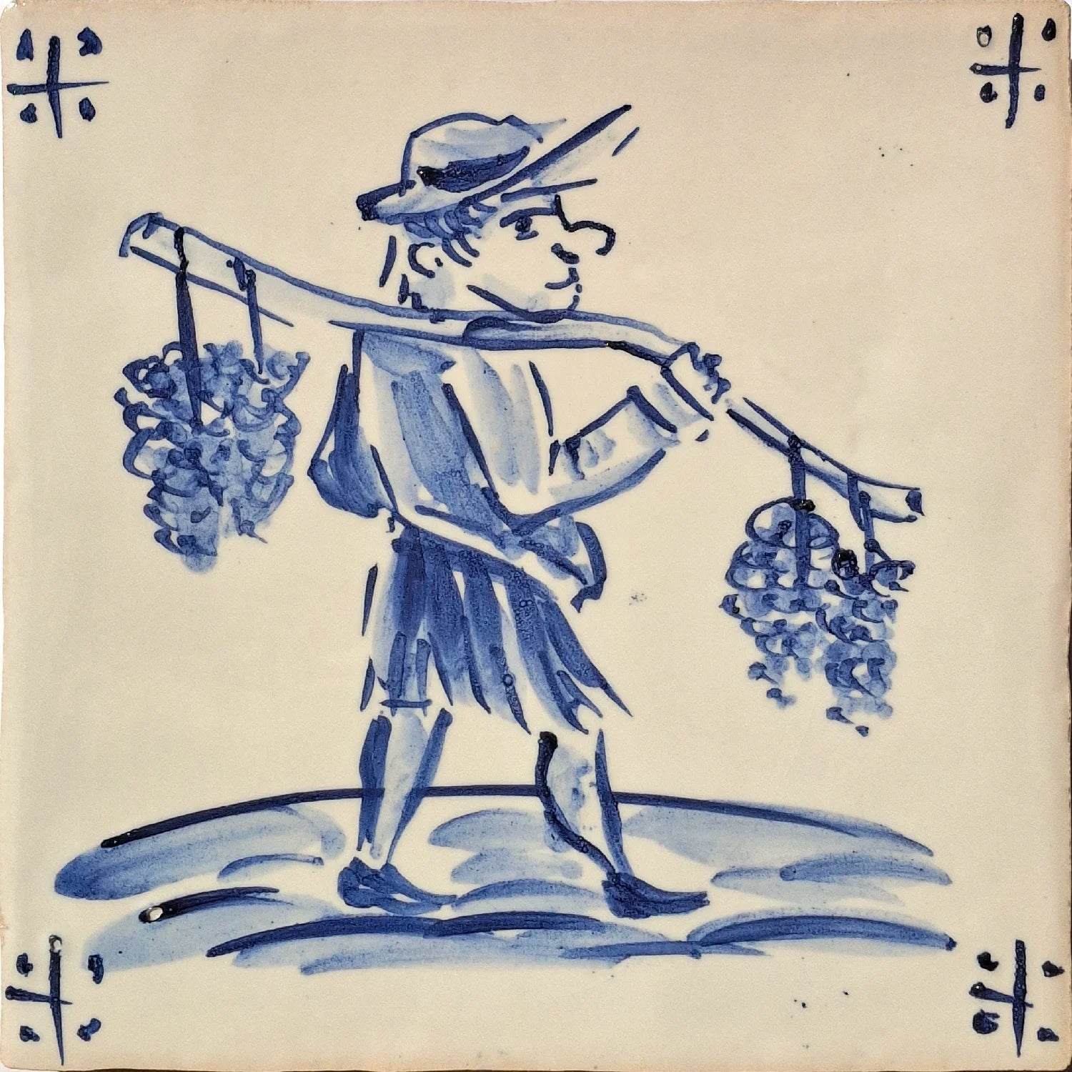 Vineyard worker carrying grape bunches