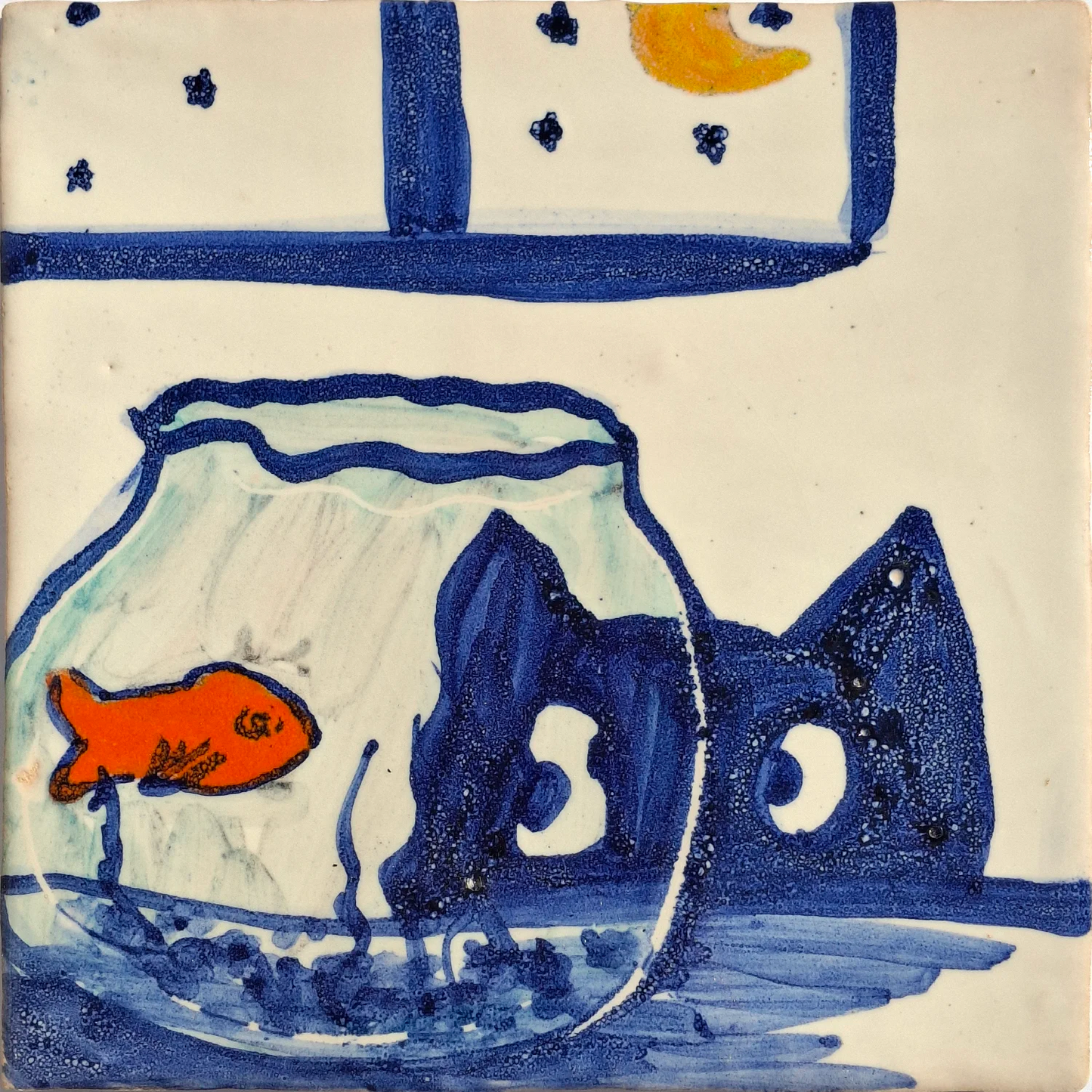Blue cat looking into a fishbowl containing a goldfish