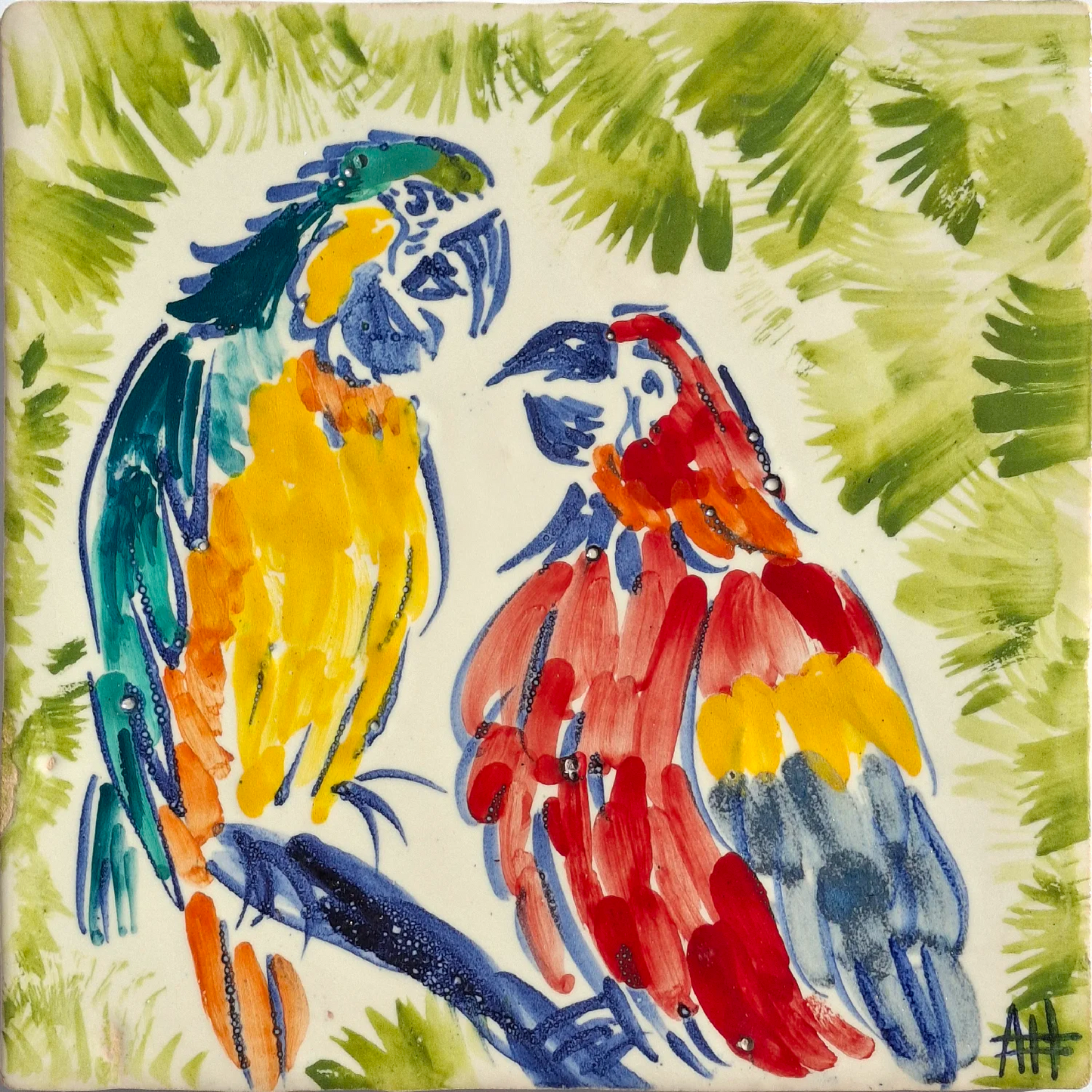Two colorful parrots on a branch with a leafy green background